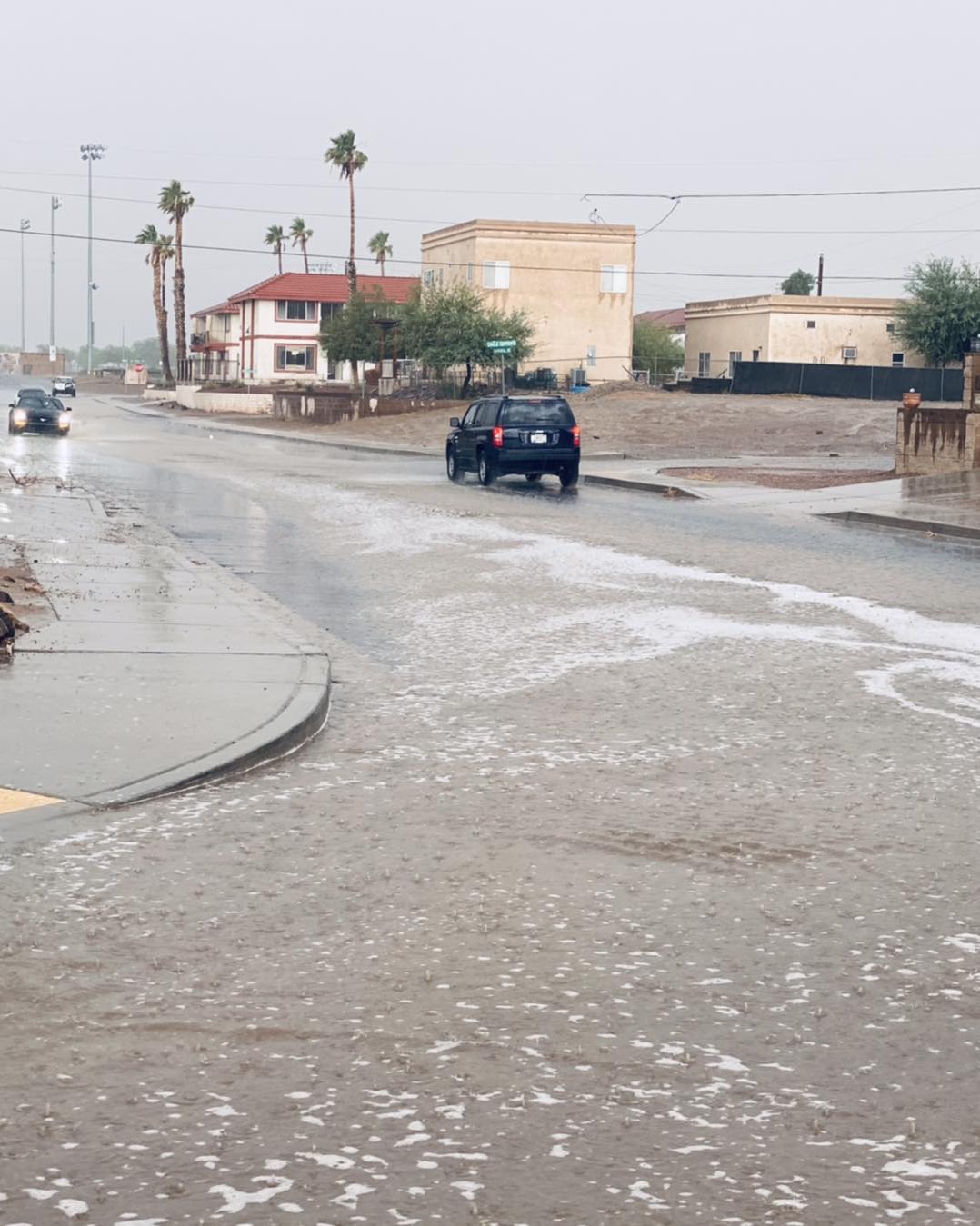 car driving through flooded road