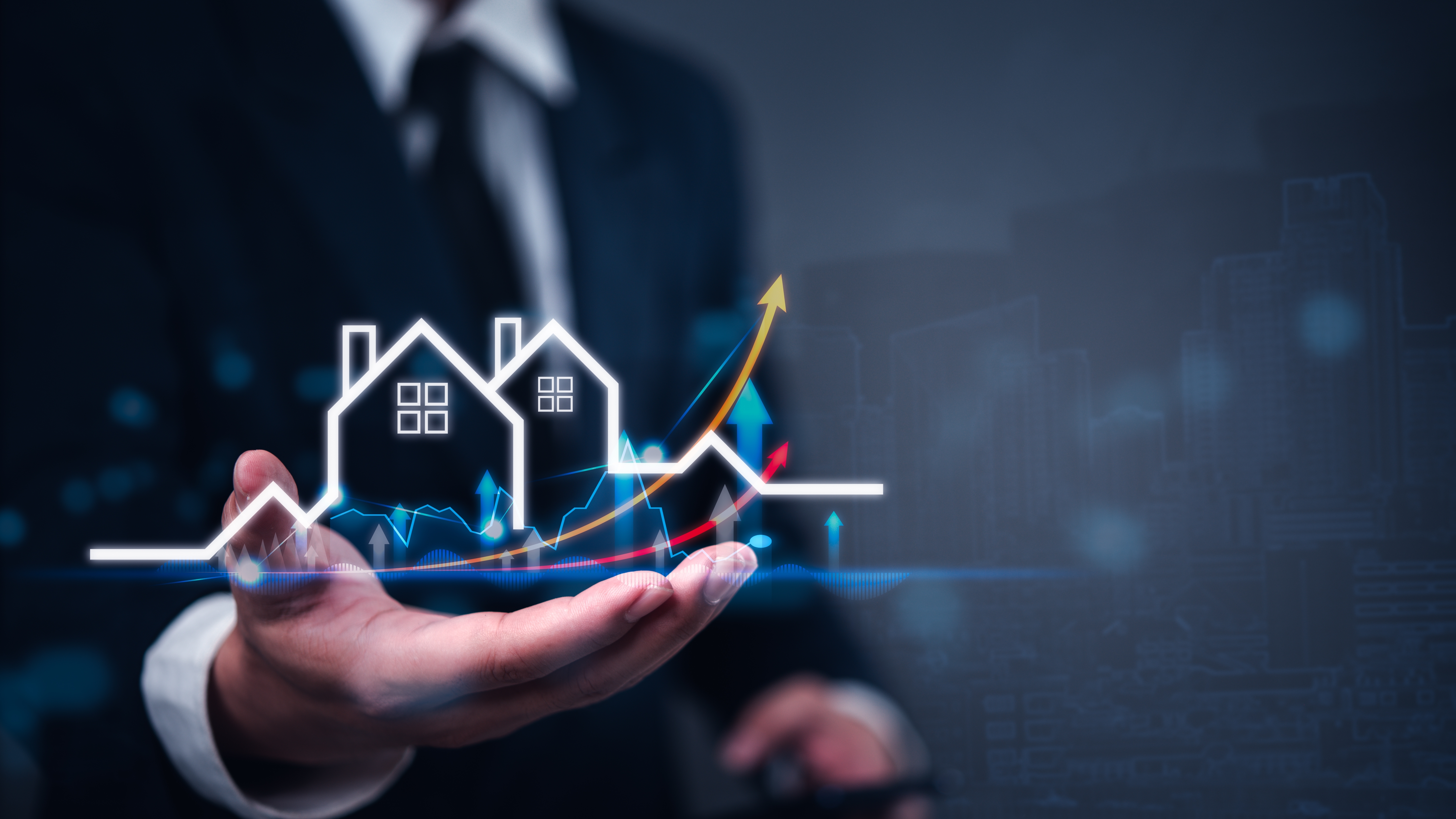 Man's hand holding digital buildings and trending arrow