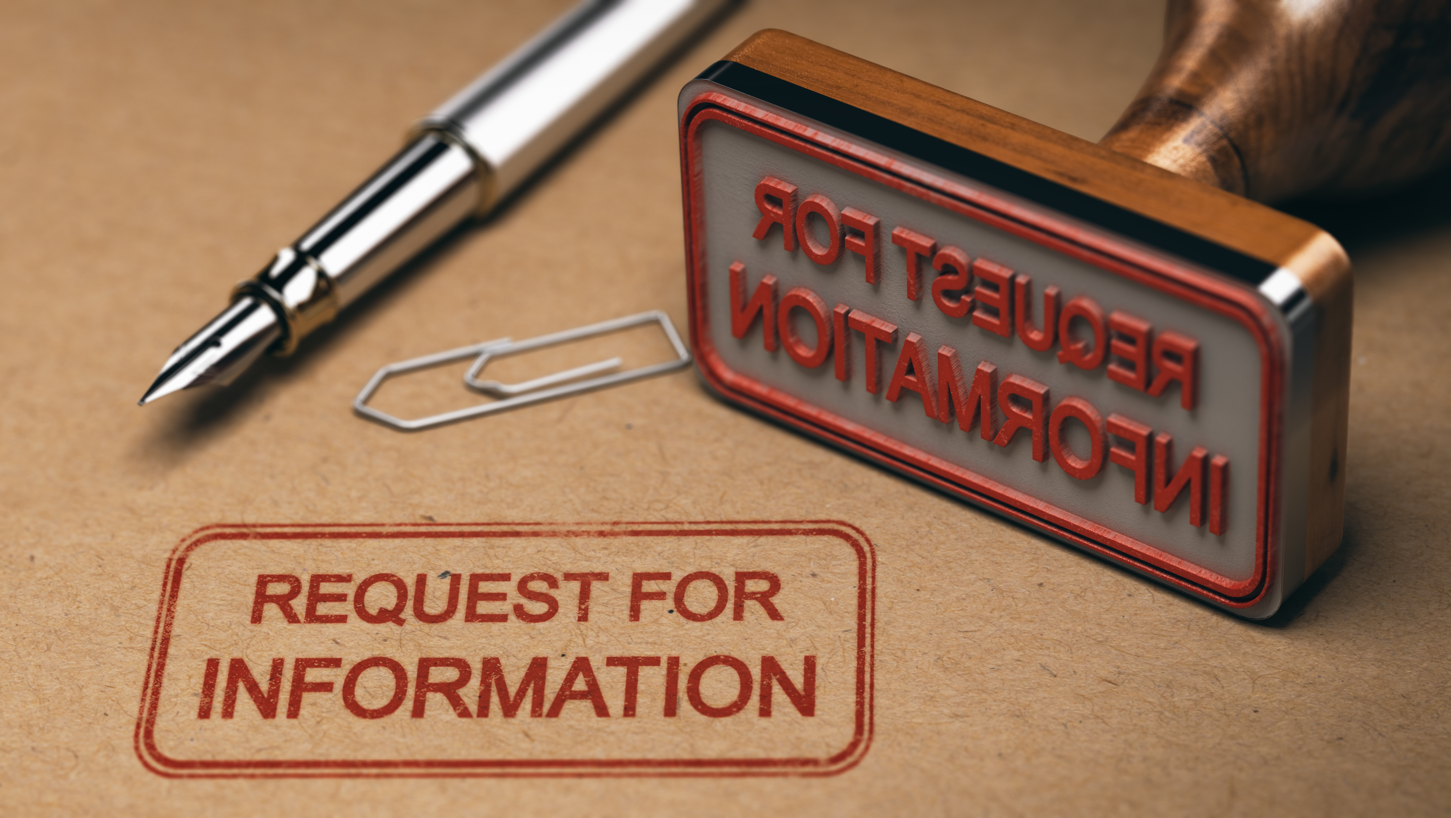 Stamp that reads "request for information" lays on top of freshly stamped document.