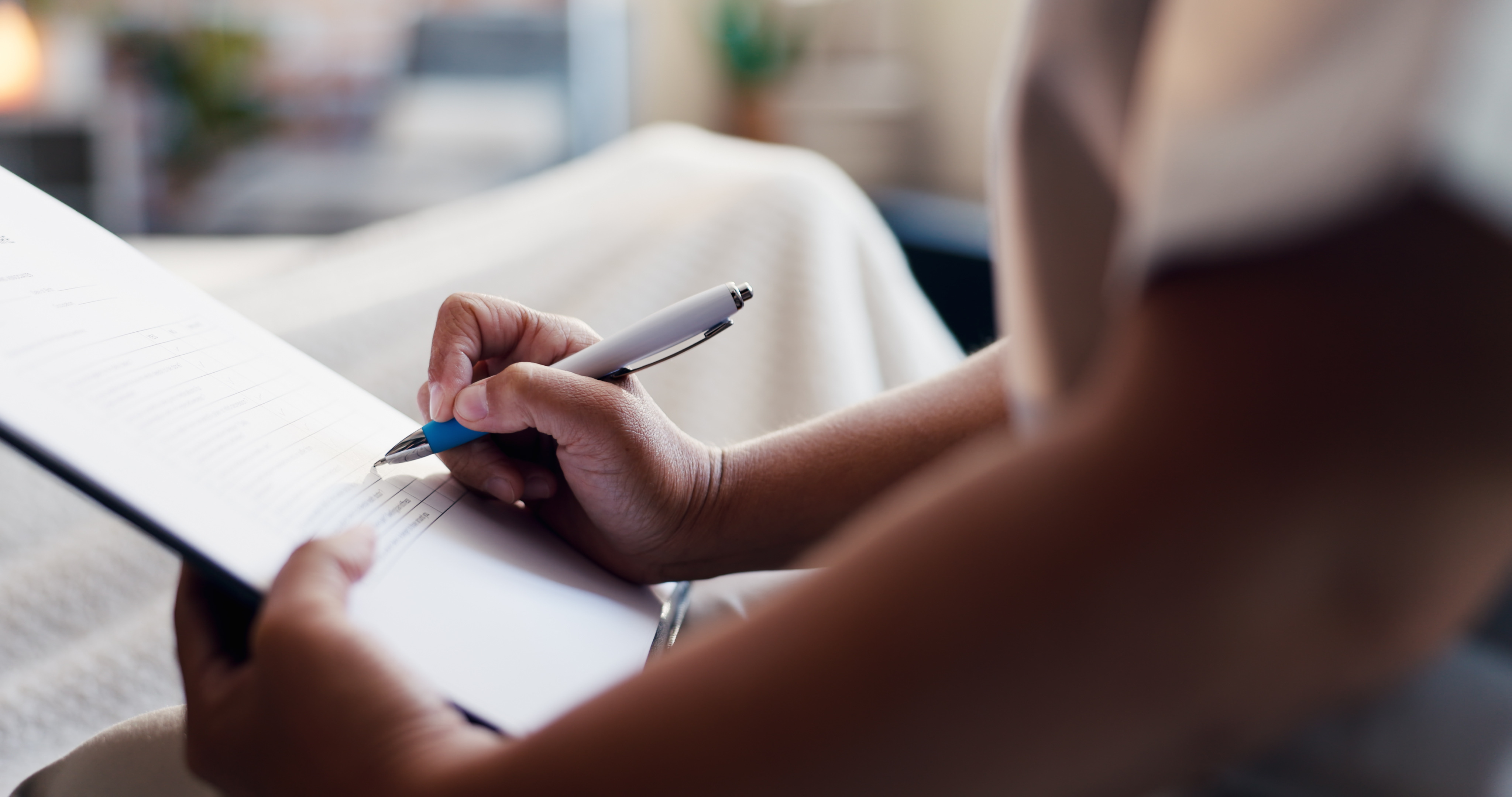 Person completing paperwork with a pen