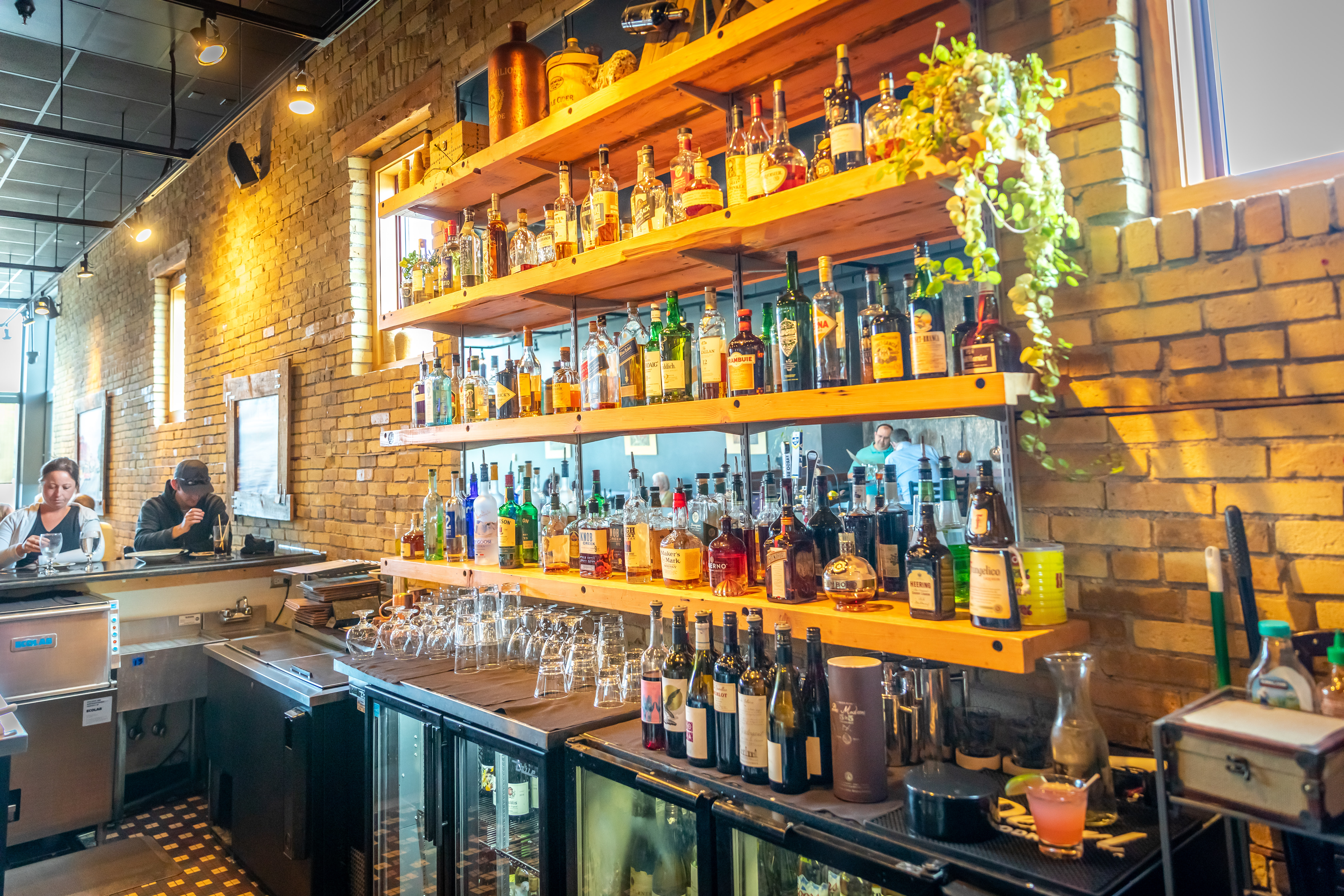Two people sit at a bar