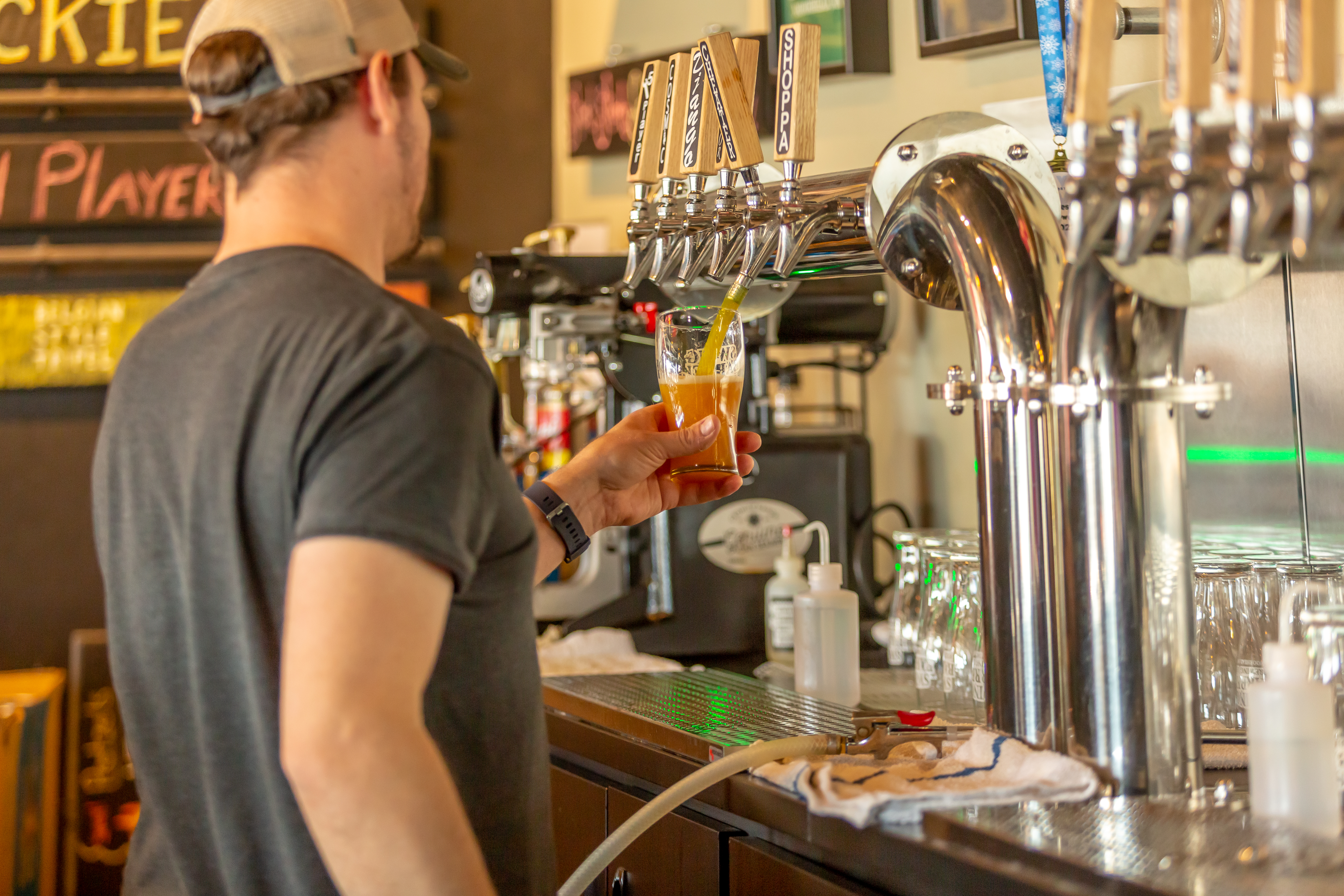 a bartender pours from the tap