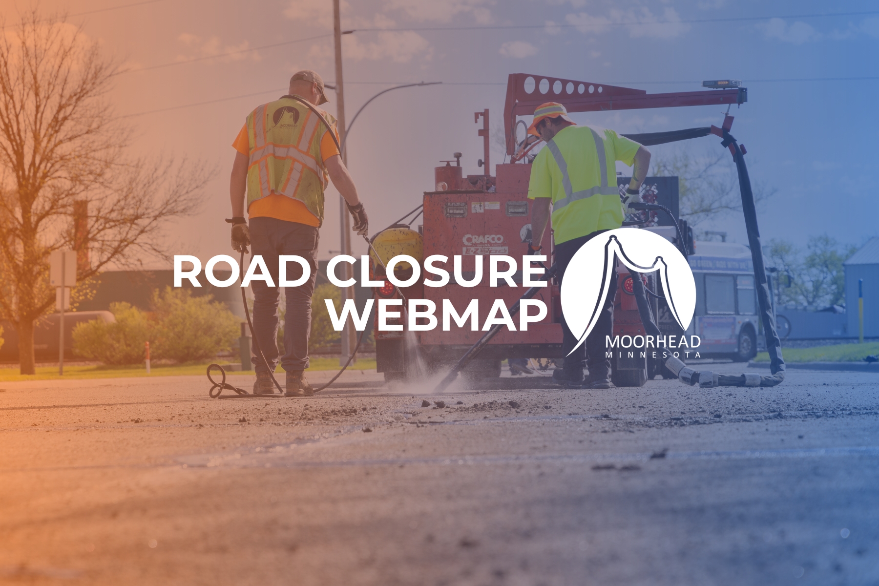 an image of people working on a road with the words Road Closure Webmap over it and the City of Moorhead logo in white